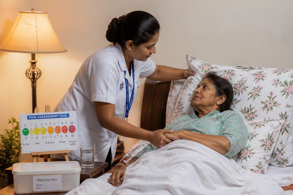 Nurse adjusting pillows and holding the hand of a cancer patient in bed for pain comfort