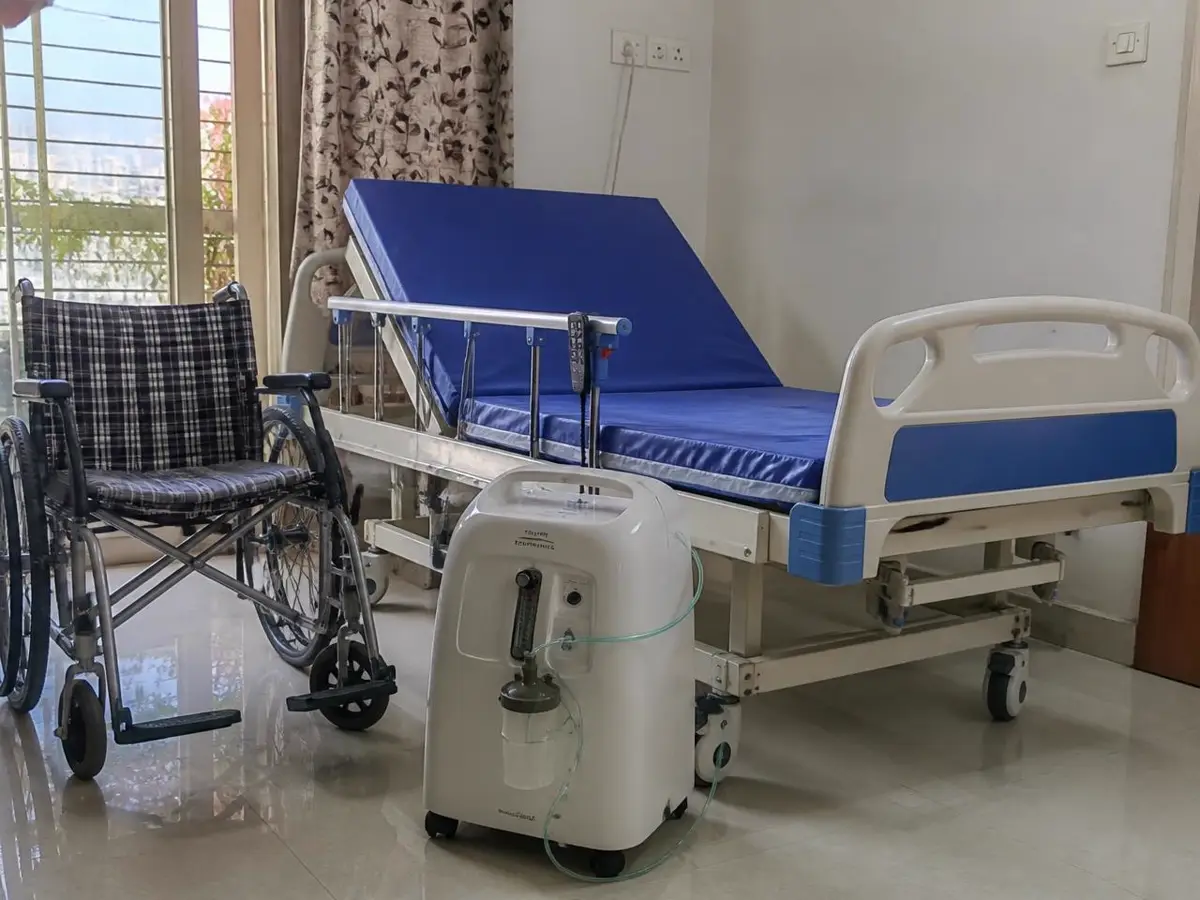 Hospital bed, wheelchair and oxygen concentrator set up in a Mumbai home