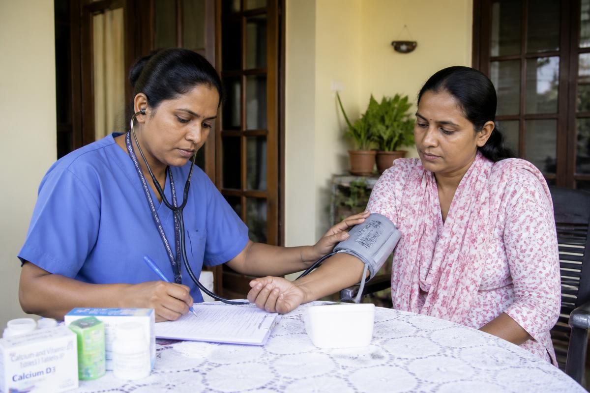 Oncology home nurse recording blood pressure and charting observations for a cancer patient
