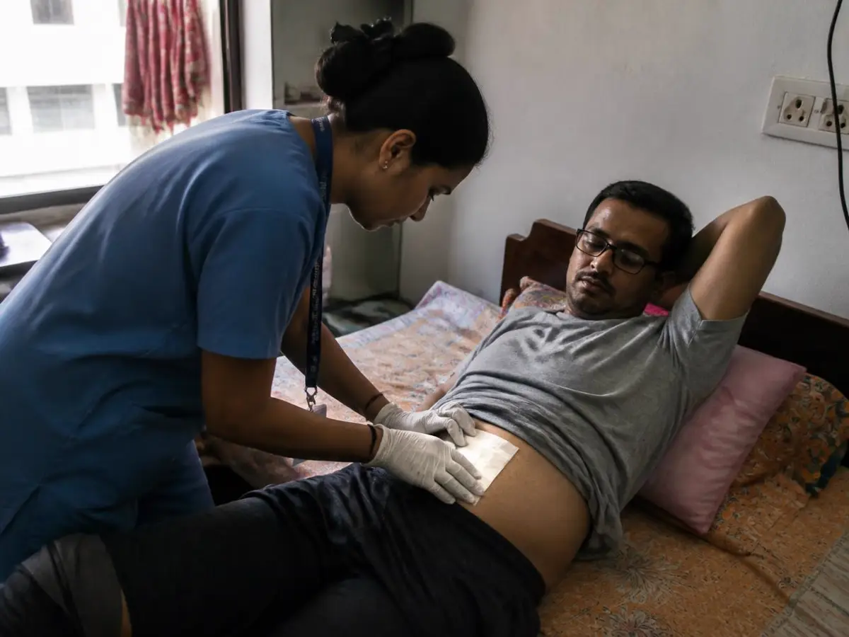 Home nurse changing a post-surgery dressing for a patient in Mumbai