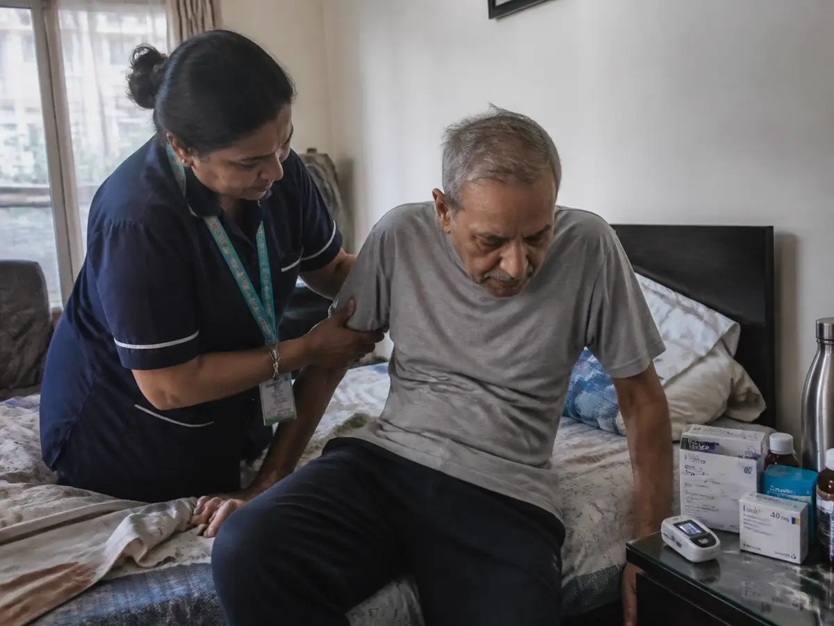 Home nurse helping a recovering patient sit up after hospital discharge